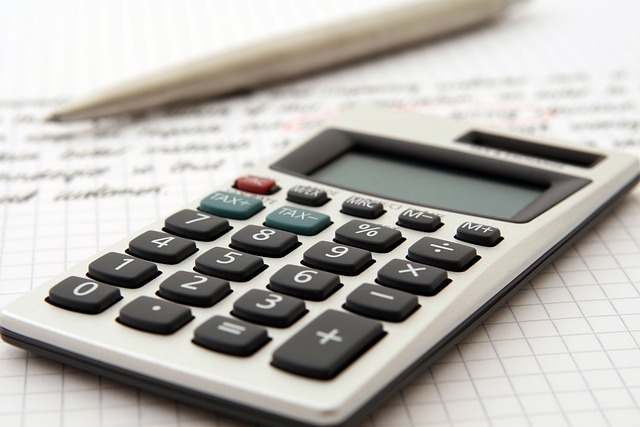 Bookkeeper vs Accountant: calculator and pen lying on hand-written paper