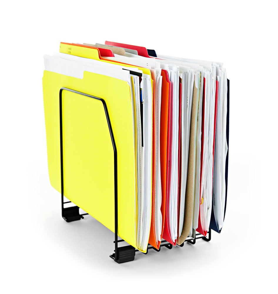 Colourful filing folders filled with papers standing on a metal stand