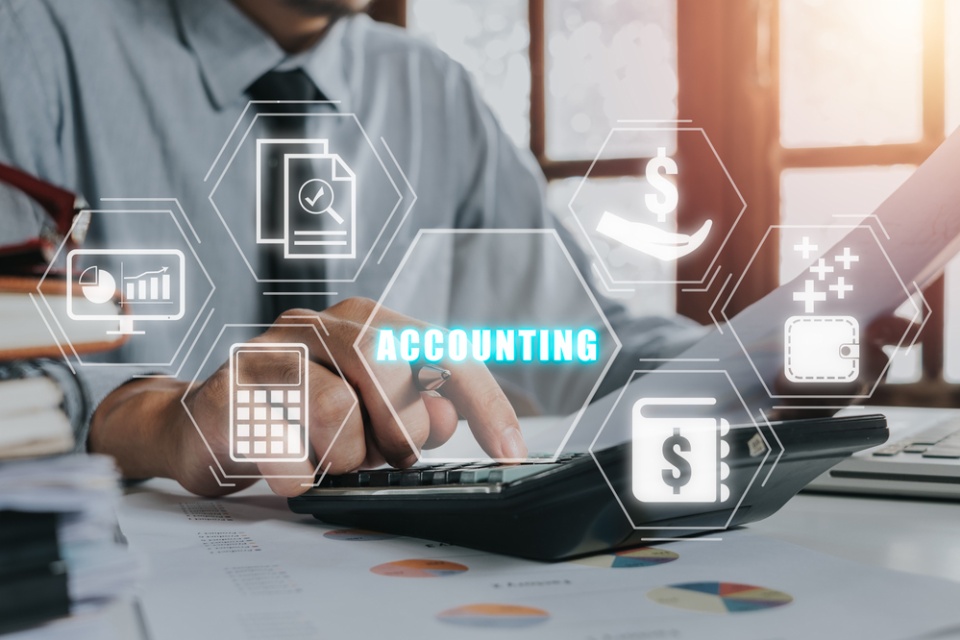 man at desk with overlay of tech symbols and word accounting