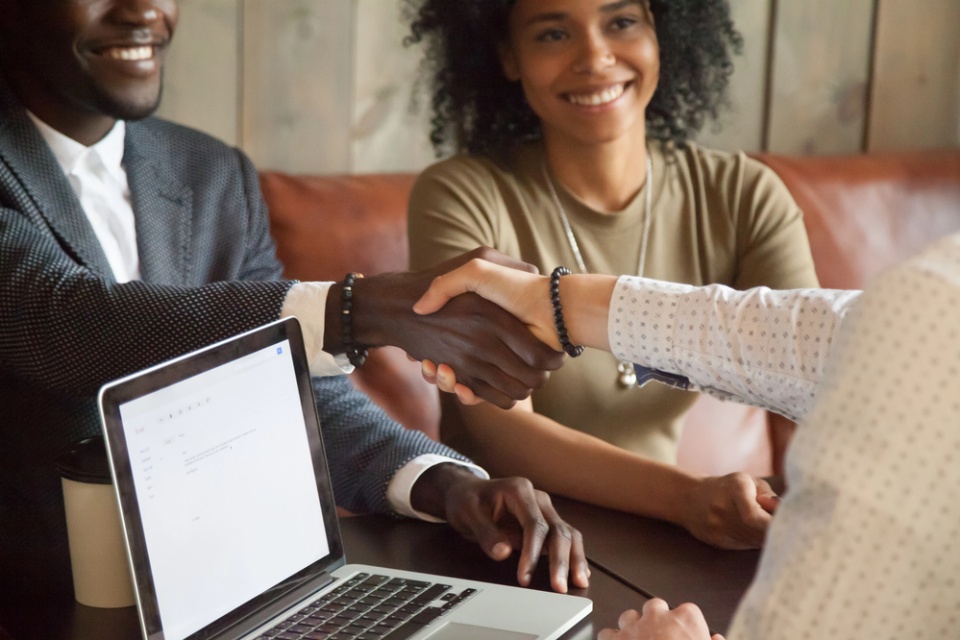 smiling man and woman shaking hands with a service provider