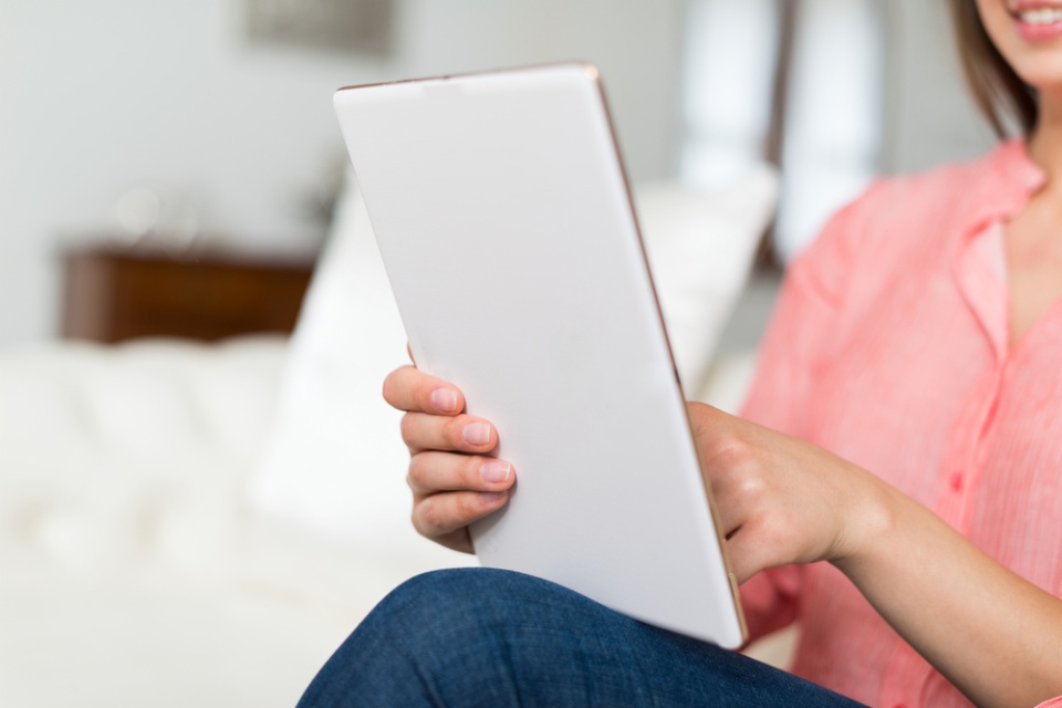 woman reading on tablet